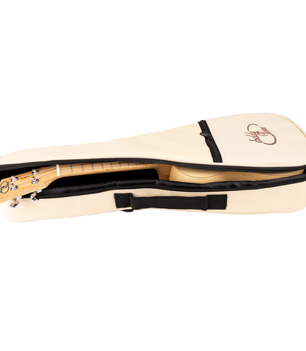 A bamboo ukulele inside a cream colored gig bag with Eddy Finn branding