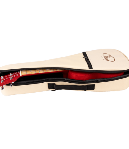 A red ukulele inside a cream colored gig bag with Eddy Finn branding