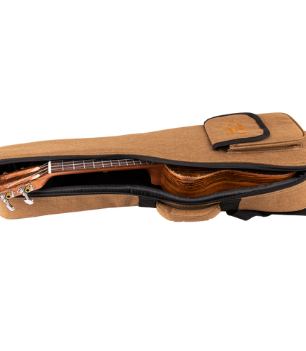 A ukulele inside a tan colored gig bag with Eddy Finn branding