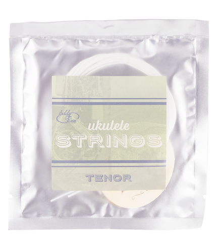 A clear package with tenor ukulele strings inside on silver backing