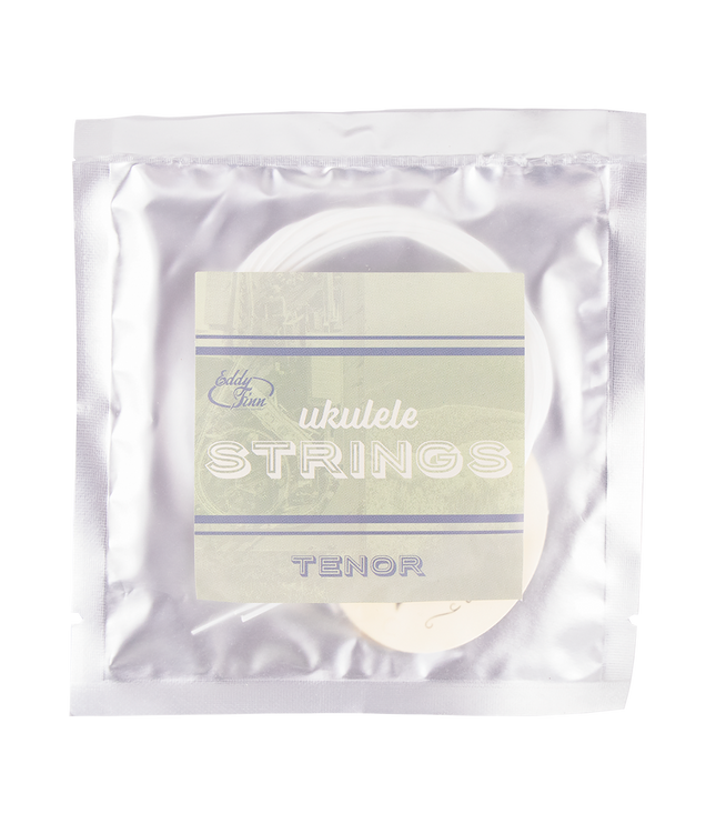 A clear package with tenor ukulele strings inside on silver backing